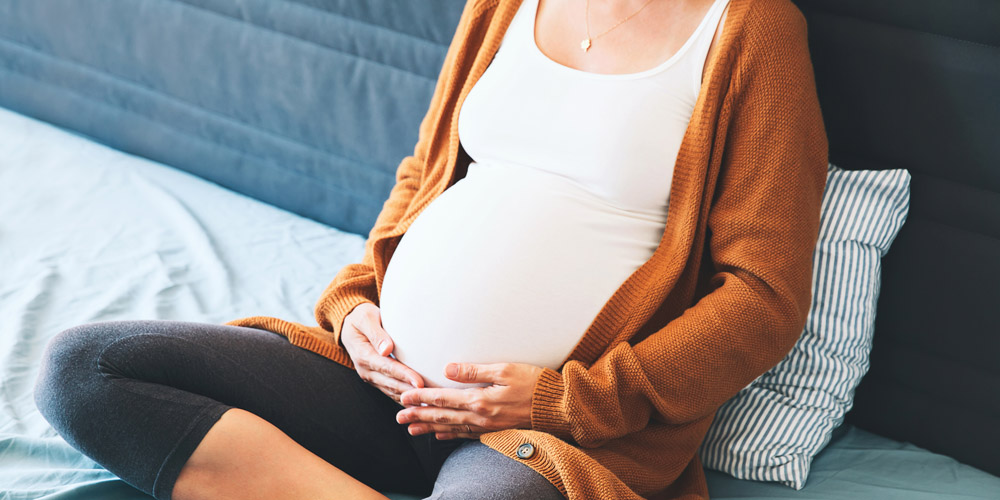 Pregnant woman holding belly 